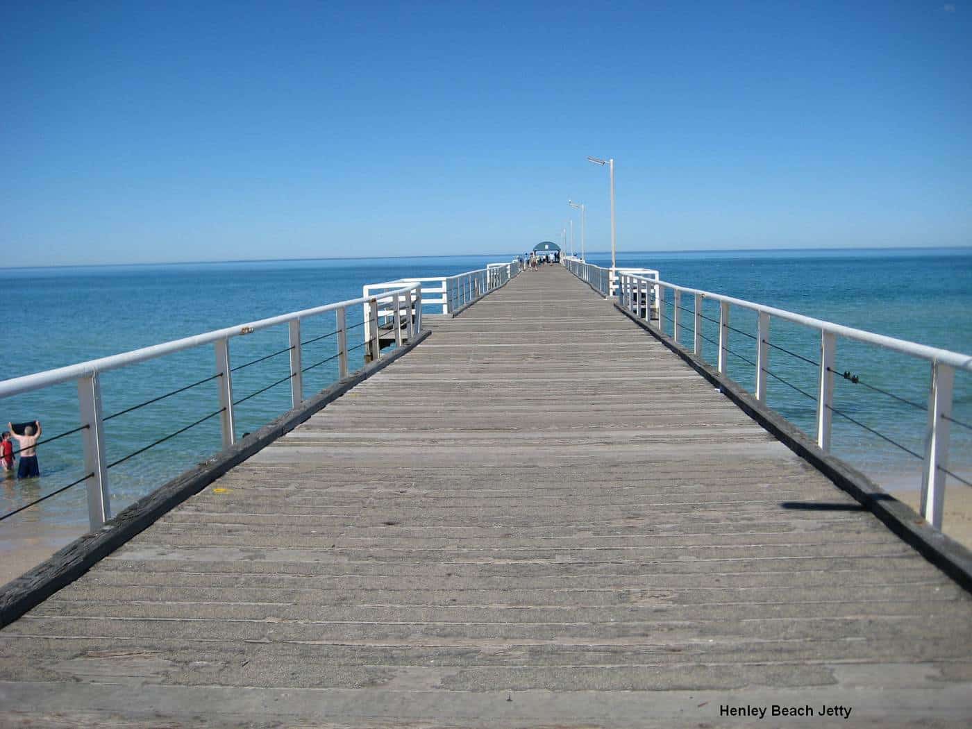 Henley Beach jetty stretching out over blue water on a sunny day